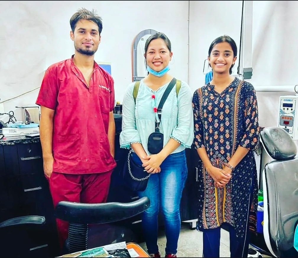 Dr. Dhruv Balooni with a happy patient after a successful braces-off appointment